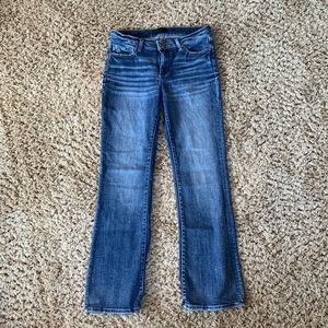 Buckle black mid rise boot cut jeans